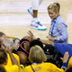 Kyle Lowry of the Toronto Raptors is pushed by Warriors minority investor Mark Stevens (blue shirt) after falling into the seats after a play on June 05, 2019 in Oakland, Calif.